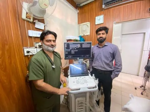 Talha with the department's cardiologist beside the MyLab A50